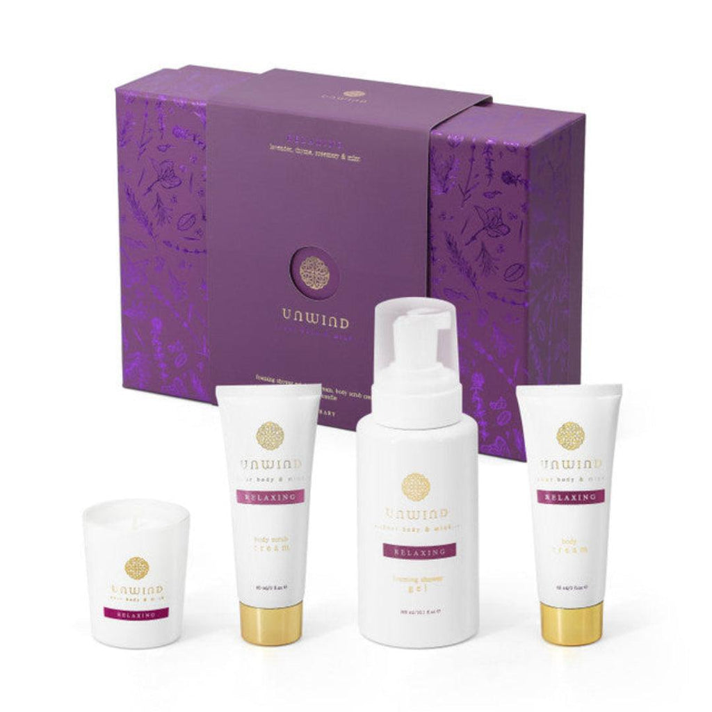 Set of skincare products with a purple box featuring 'Unwind' branding on a white background.