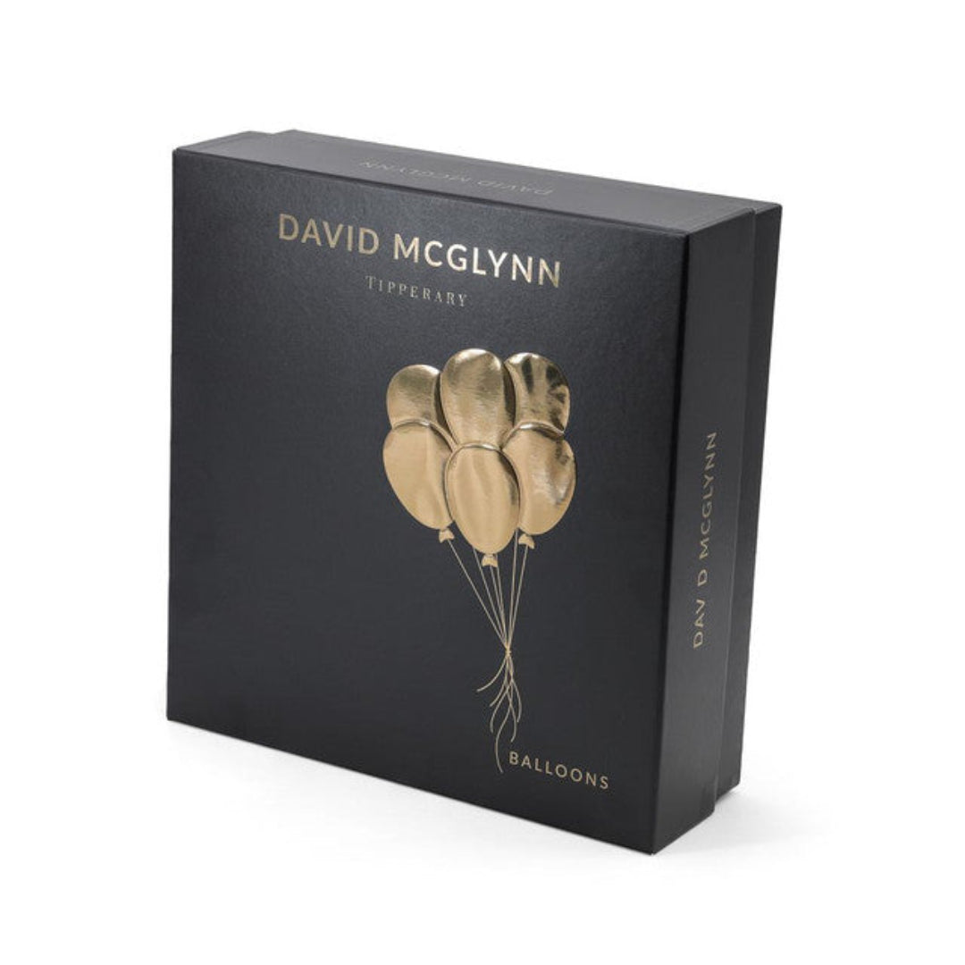 Black box with gold balloons design and 'David McGlynn' branding on a white background
